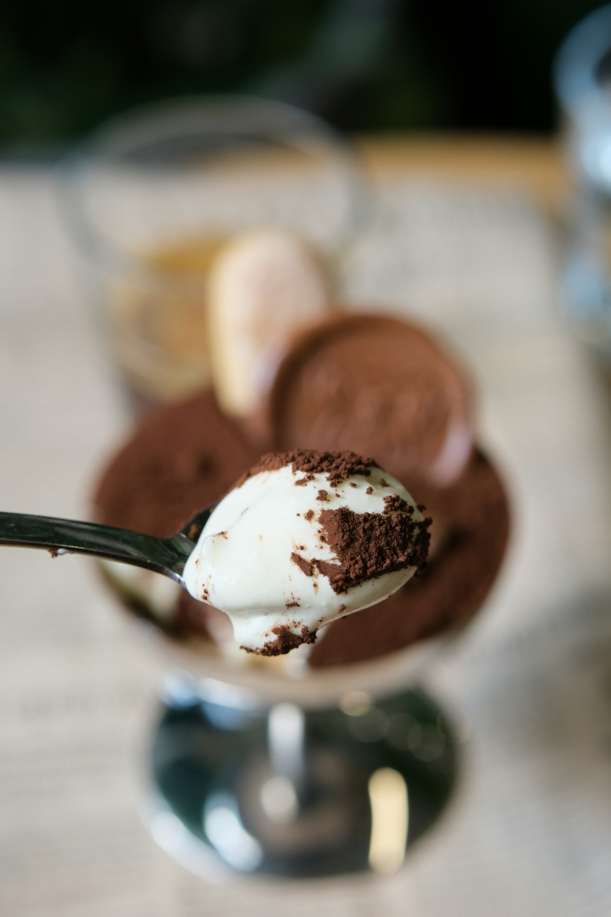 Cocoa-dusted tiramisu cream served elegantly on a spoon